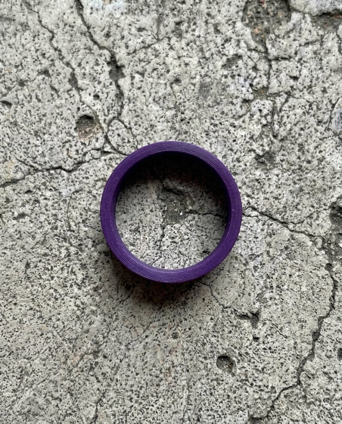 FK U** RINGS — Purple smooth ring on concrete above — ATTITUDE DESIGN